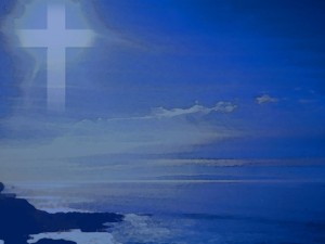 Cross in Blue Sky Over Ocean